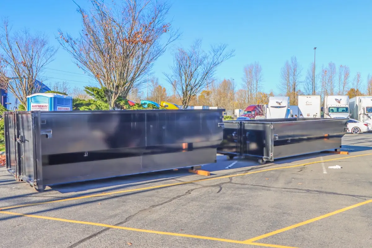 Professional dumpster rental service with roll-off container on residential driveway in Hempstead